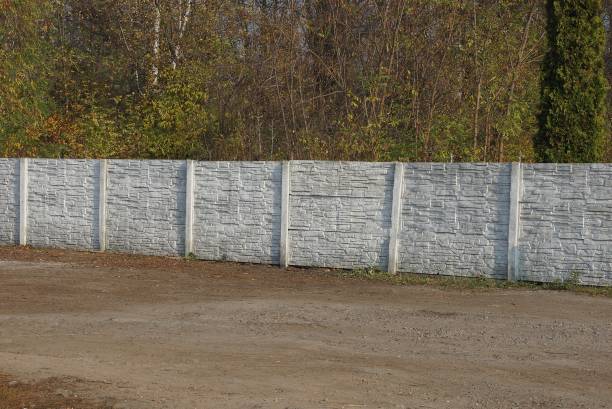 istock concrete white fence on a rural street 1184709921