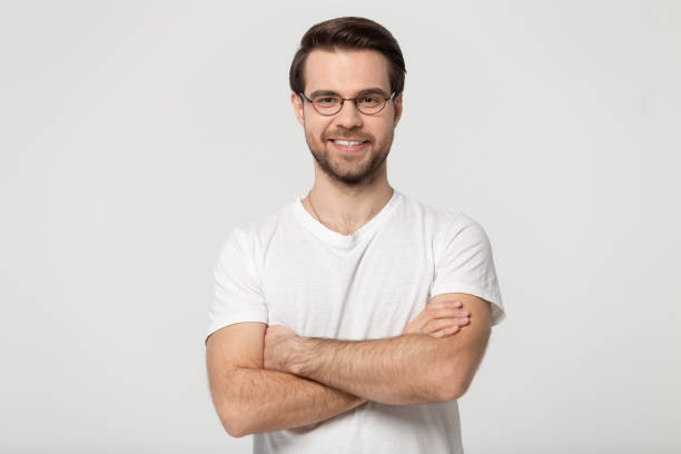 istock Happy millennial confident man in glasses standing with folded hands. 1184709947