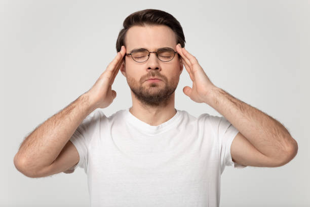 istock Stressed young guy in eyeglasses suffering from headache. 1184709948