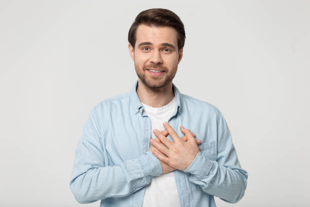 istock Grateful millennial guy folded hand on chest near heart. 1184709975
