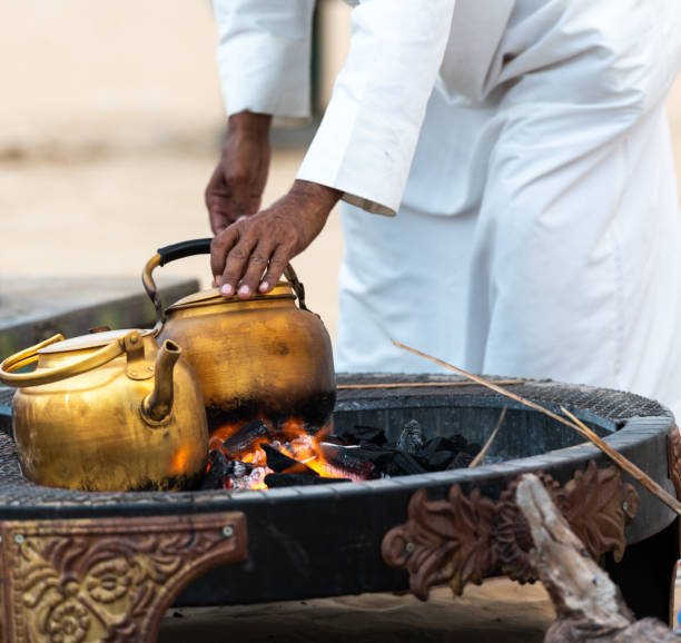 beduin tradition, roasting and making arabic Coffeys and tea over the open fire place in the desert coffee making in the desert on the open fire pace bedouin stock pictures, royalty-free photos & images