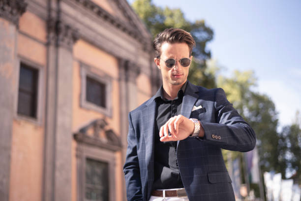 istock Young businessman checking the time on wristwatch 1184712636