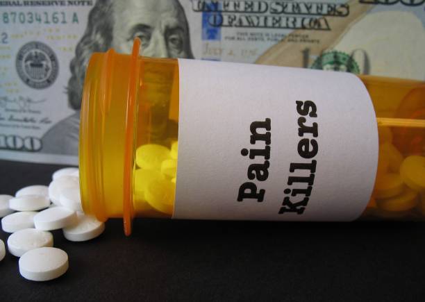 istock Prescription pain killers and a hundred dollar bill 1184714848