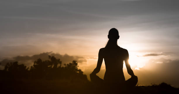 istock Relaxed woman enjoying beautiful sunset 1184718486