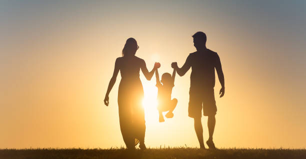istock Happy family at sunset 1184718537