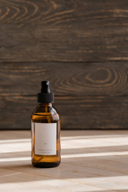 istock Cosmetic dark amber bottles on wooden  table 1184723210