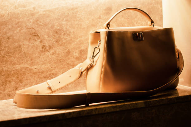 istock Woman's beige handbag on marble 1184723827