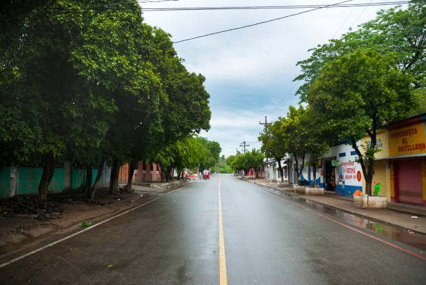 Guatemala, El Jicaro – May 27, 2012: Street in rural Guatemala, asphalt wet with rain. El Progreso.