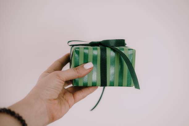 istock Woman holding green color gift box 1184728641