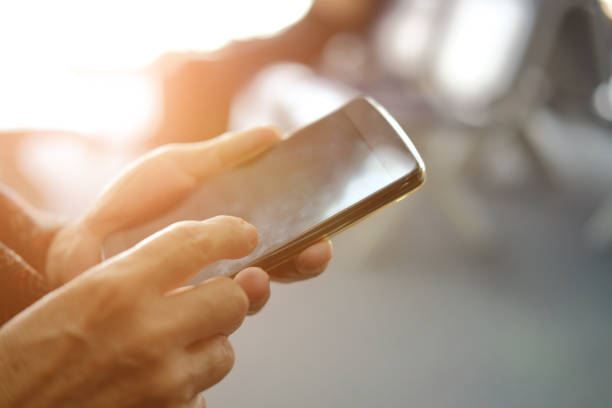 istock hand holding mobile smart phone at airport 1184729387