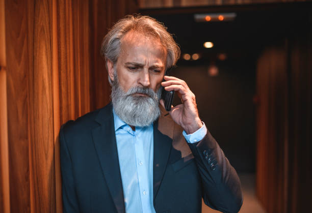 istock Emotionally Stressed Senior Businessman Using Smart Phone 1184729519