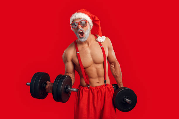 istock Brutal and strong Santa Claus training with dumbbell 1184729917