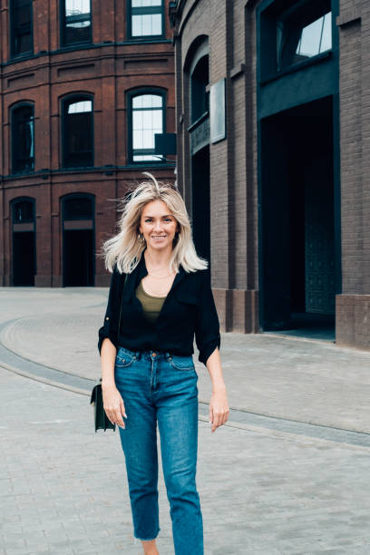 istock Woman walking on a street 1184732195