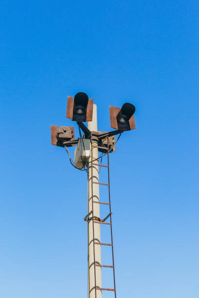istock Rusty railroad lights and blue sky outdoors 1184735943