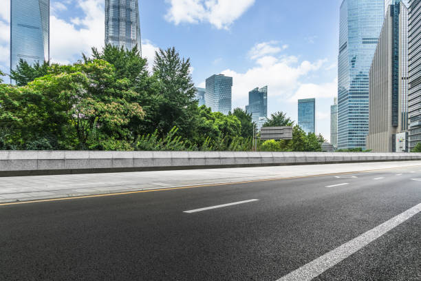 istock empty asphalt road with city skyline background in china 1184736035