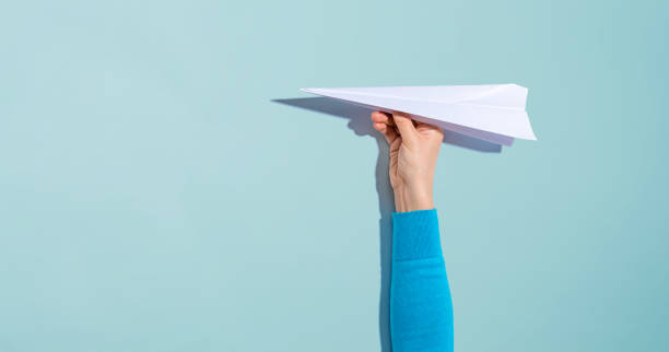 istock Person holding a paper airplane 1184747461