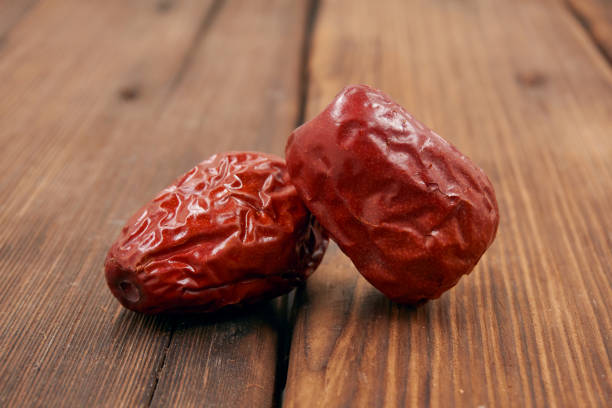 istock Jujube, Chinese dried red date fruit on wood background. 1184750644