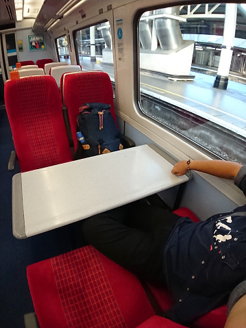 Salisbury, Wiltshire, England - 1 July 2019: A traveler selfie inside the train, first class seats.