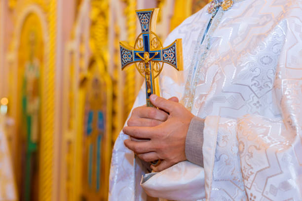 istock Orthodox priest holds with a cross in his hands 1184758384