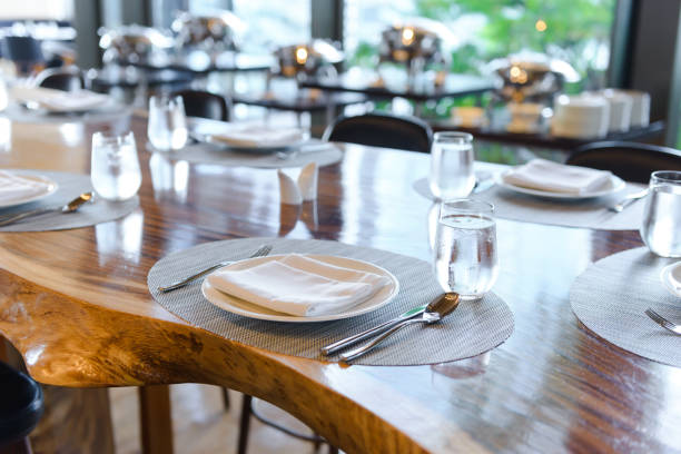 istock Tableware setting in the restaurant. Decorated elegant table, porcelain plates, glasses, napkin, knife, fork and spoon on wooden table 1184765371