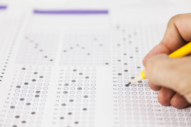 istock students hand doing exams quiz test paper at school 1184767031