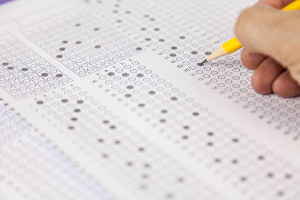 istock students hand doing exams quiz test paper at school 1184767040