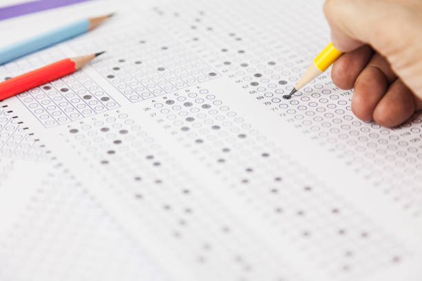 istock students hand doing exams quiz test paper at school 1184767043