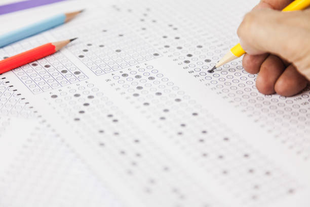 istock students hand doing exams quiz test paper at school 1184767047
