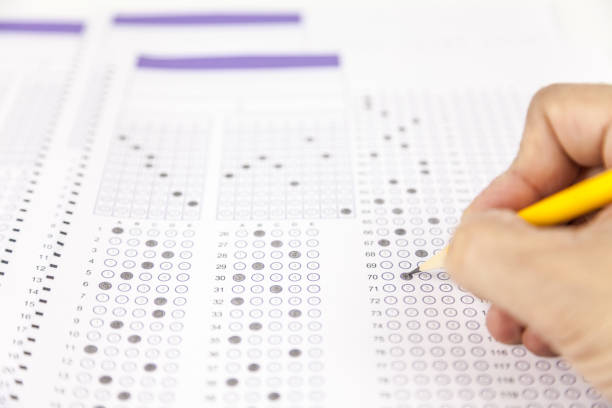 istock students hand doing exams quiz test paper at school 1184767054