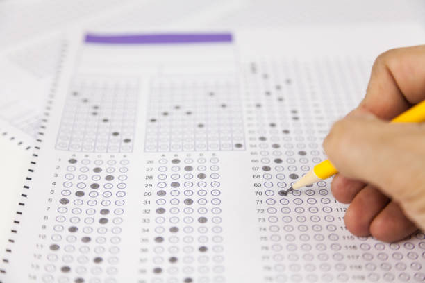istock students hand doing exams quiz test paper at school 1184767055