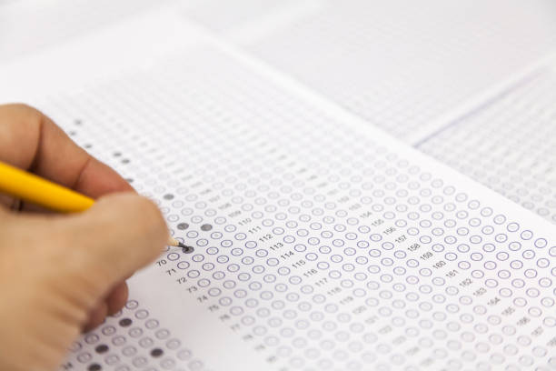 istock students hand doing exams quiz test paper at school 1184767056
