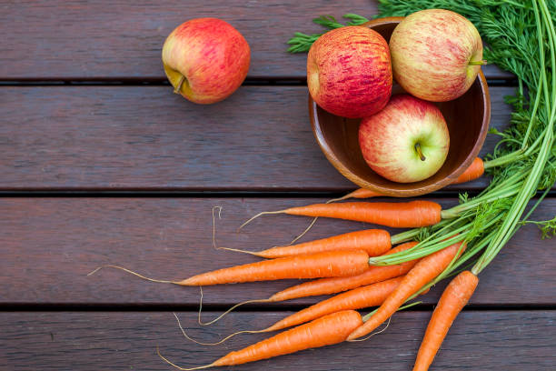 istock Carrots and apples on the wood 1184768257