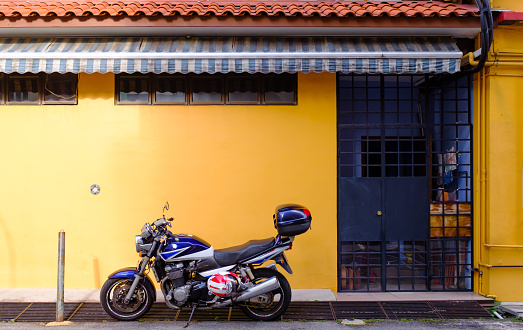 Singapore-24 MAR 2018: Motorcycle in front of a residential building in Singapore traditional area
