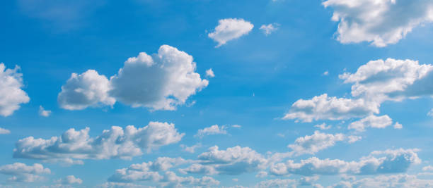 istock white cloud on blue sky background with sunshine 1184776702