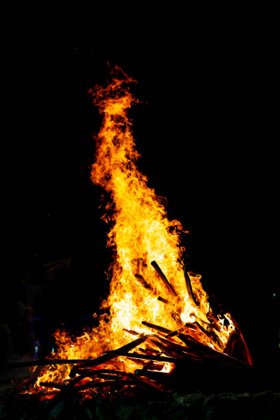 istock Bonfire that burns on a dark background, wood burning flame. 1184778596