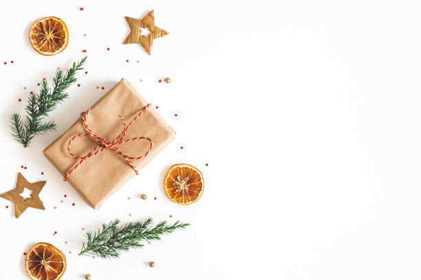 Christmas composition. Gift box, fir tree branches, golden decorations on white background. Christmas, winter, new year concept. Flat lay, top view, copy space