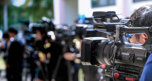 Press conference Close-up of Video camera on blurred group of press and media photographer as background 4k resolution stock pictures, royalty-free photos & images