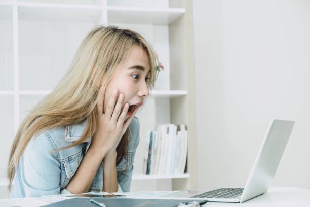 istock Wow Shock and surprised expression girl when looking at laptop computer screen and see shocking things for good news concept. 1184783187