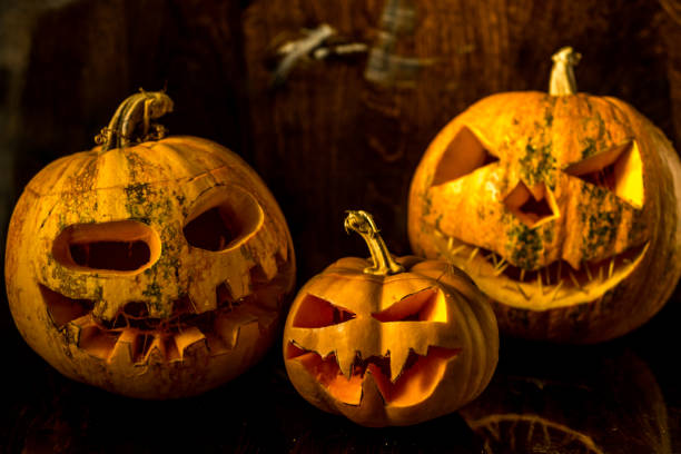 istock halloween pumpkin and candle background 1184783231