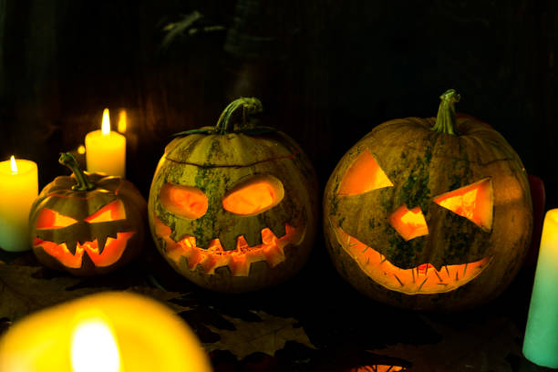 istock halloween pumpkin and candle background 1184783804