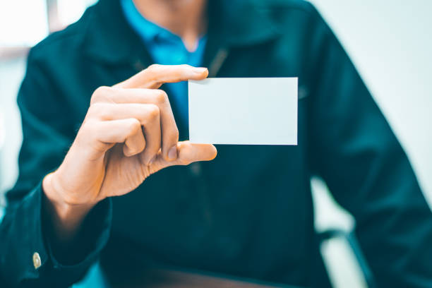 istock Business Man holding white card 1184784903