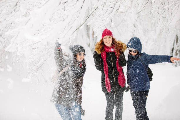 istock Cheerful friends having fun on snow 1184787218