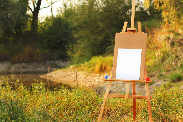 istock Easel with paints on a background of nature 1184787577