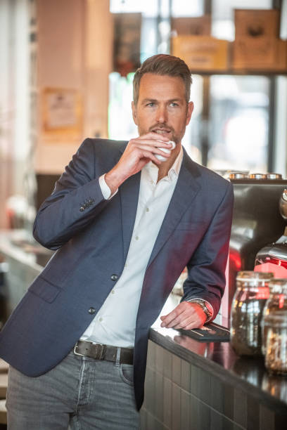 istock Man drinking espresso on his coffebreak 1184788413