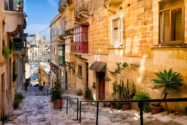 View from the narrow street in Isla to the parish church and marine in Birgu, Malta