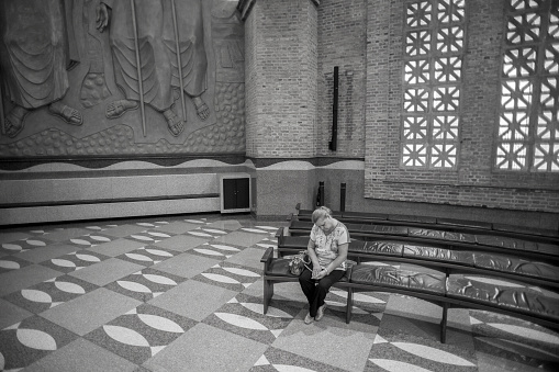 Aparecida, São Paulo, Brazil - January 13, 2016:  Brazilian woman prays at Cathedral of Nossa Senhora  Aparecida National Sanctuary