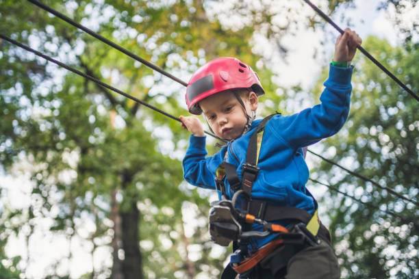 istock Cute little boy goes through an obstacle course in an adventure park 1184798622