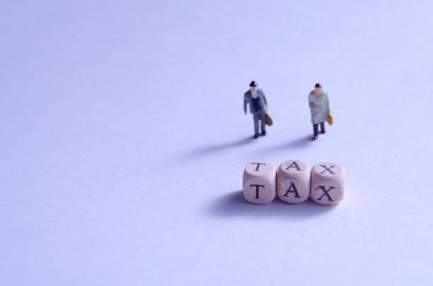 istock Taxes and miniatures that must be paid 1184803483