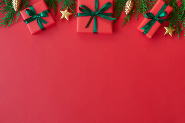 istock Red gift box on red background. Christmas card. Flat lay. Top view with space for text 1184807150