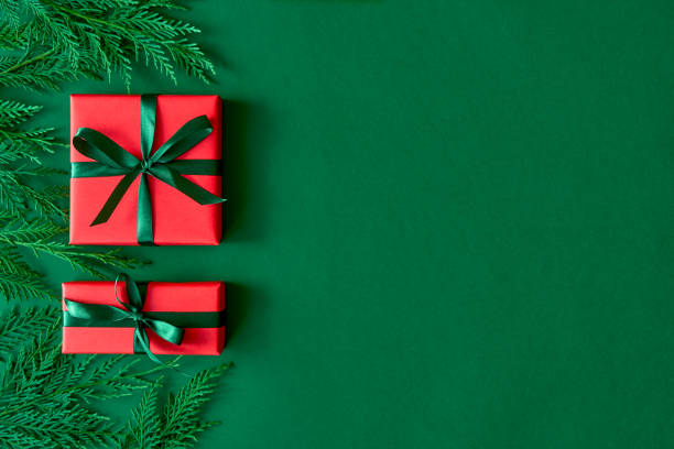 istock Christmas flat lay background with fir tree, present box on green. Free space for design. 1184807902